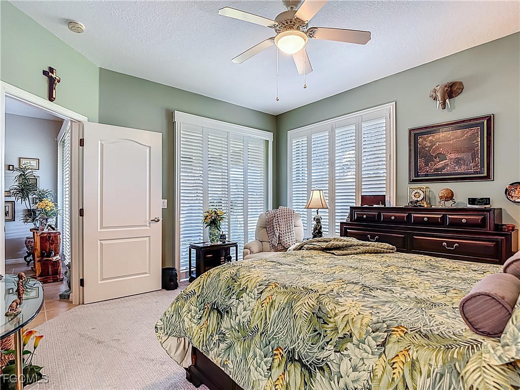 3630 Rue Alec Loop, Unit 1 North Fort Myers, FL 33917 - Photo 22 of 50 a bed room with a bed and a chandelier