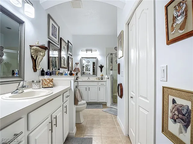 a spacious bathroom with a sink a mirror a vanity and a shower