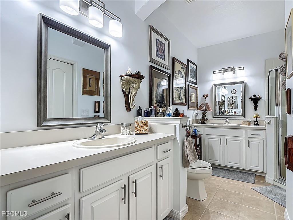 3630 Rue Alec Loop, Unit 1 North Fort Myers, FL 33917 - Photo 24 of 50 a bathroom with a double vanity sink mirror and toilet