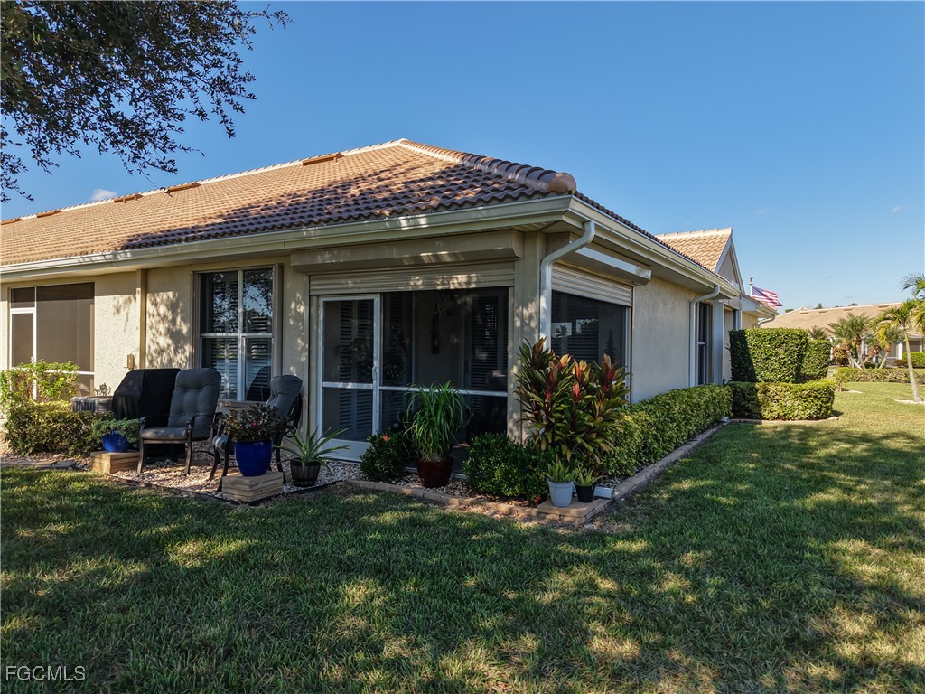 3630 Rue Alec Loop, Unit 1 North Fort Myers, FL 33917 - Photo 36 of 50 a front view of a house with garden