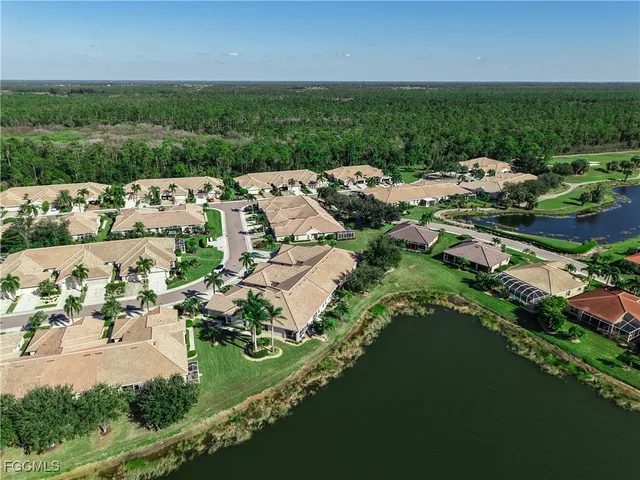 an aerial view of a house with a garden and lake view