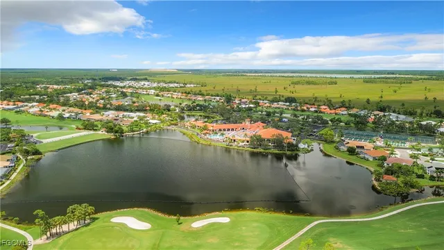 an aerial view of residential houses with outdoor space and swimming pool