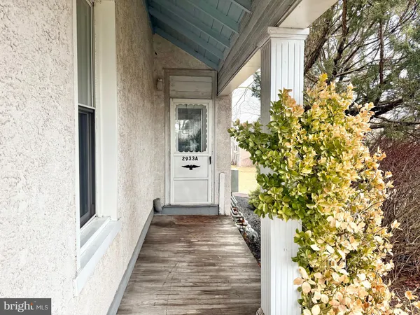 a view of a pathway of a house with potted plants