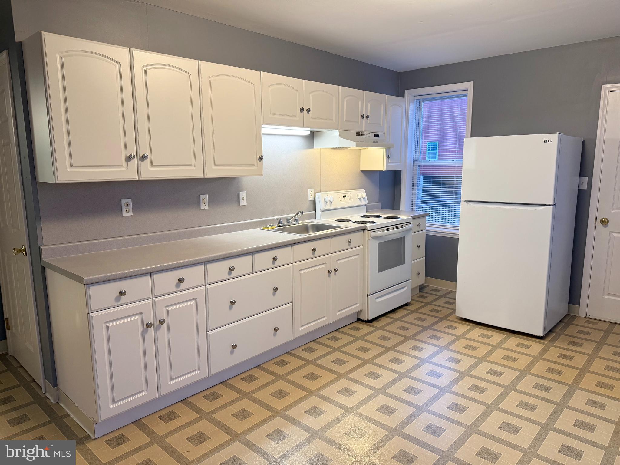 2933 West High Street Pottstown, PA 19464 - Photo 6 of 15 a kitchen with a white cabinets and white appliances