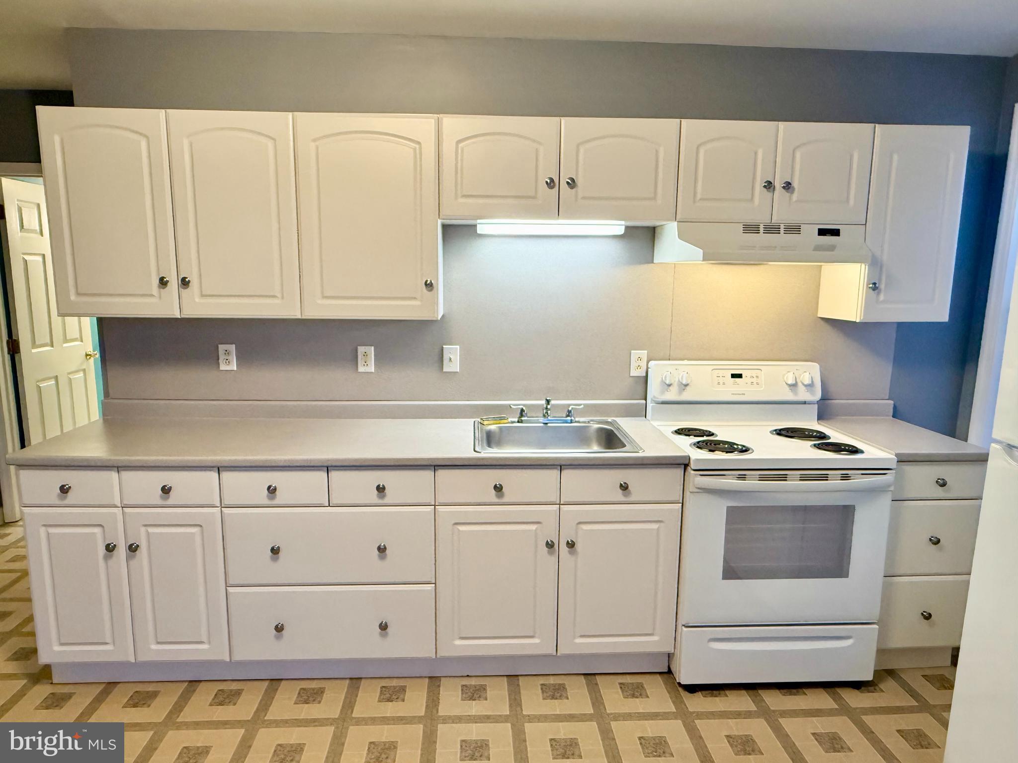 2933 West High Street Pottstown, PA 19464 - Photo 7 of 15 a kitchen with granite countertop white cabinets and stainless steel appliances