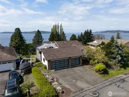 an aerial view of a house with a yard and potted plants