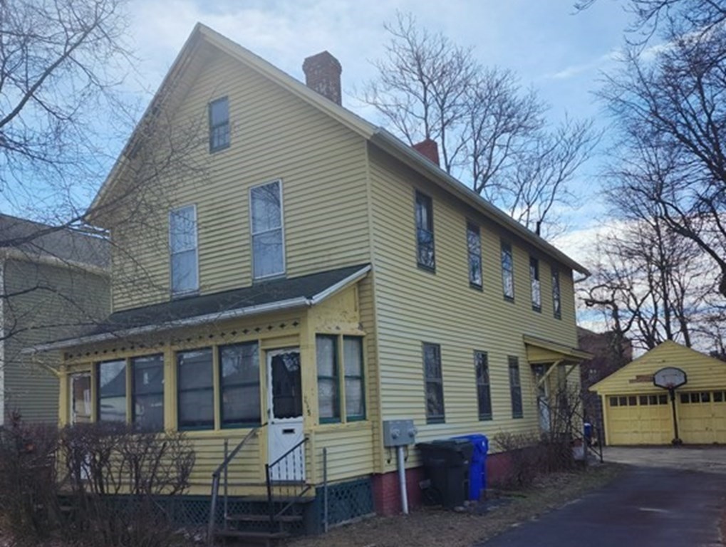 115 Greene Street Springfield, MA 01109 - Photo 2 of 4 a view of a house with a yard and wooden fence