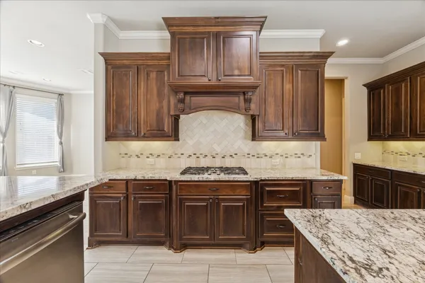 a kitchen with granite countertop a sink and a stove