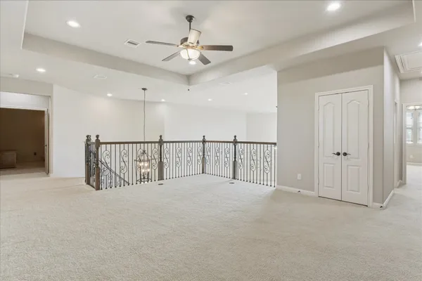 a view of a hallway with a ceiling fan