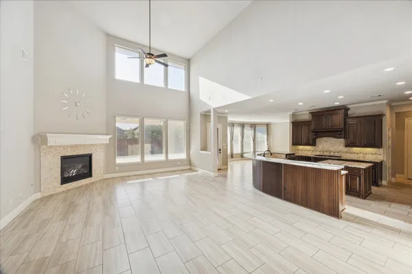 a large kitchen with stainless steel appliances granite countertop a stove and a wooden floors