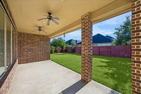 a view of a porch in front of a house with a yard