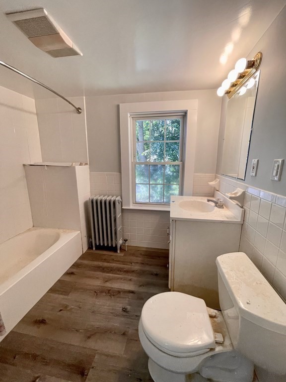 767 North Main Street, Unit 1 Randolph, MA 02368 - Photo 6 of 12 a bathroom with a toilet a sink and bathtub