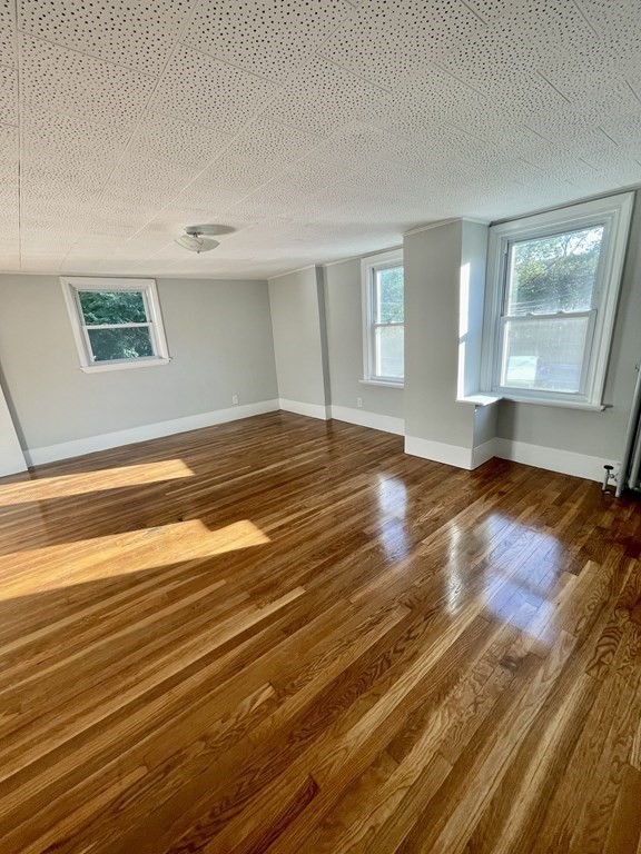 767 North Main Street, Unit 1 Randolph, MA 02368 - Photo 9 of 12 a view of empty room with wooden floor and fan