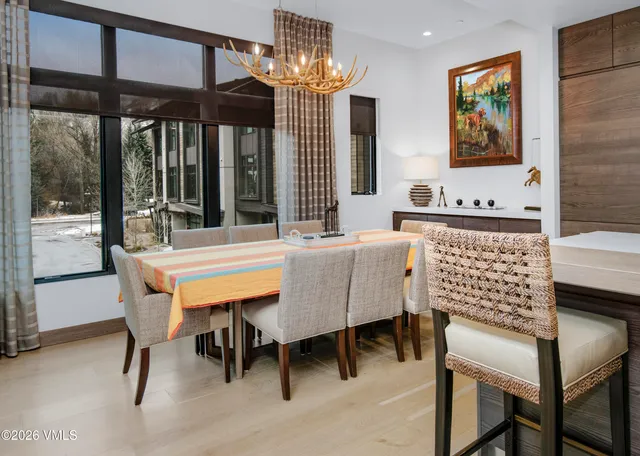 a view of a dining room with furniture and chandelier
