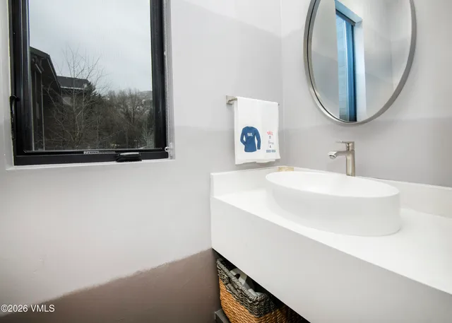a bathroom with a sink double vanity and a mirror