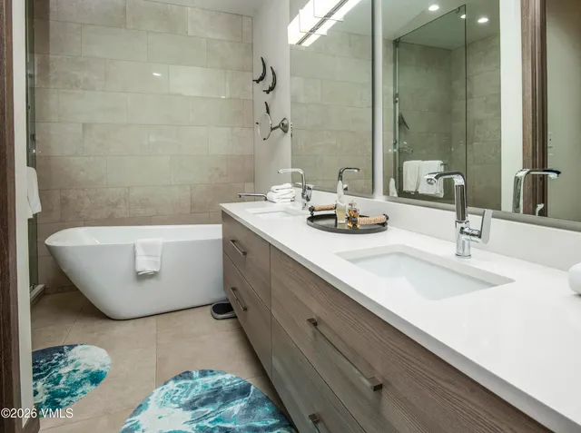 a spacious bedroom with a bed couch and a large window