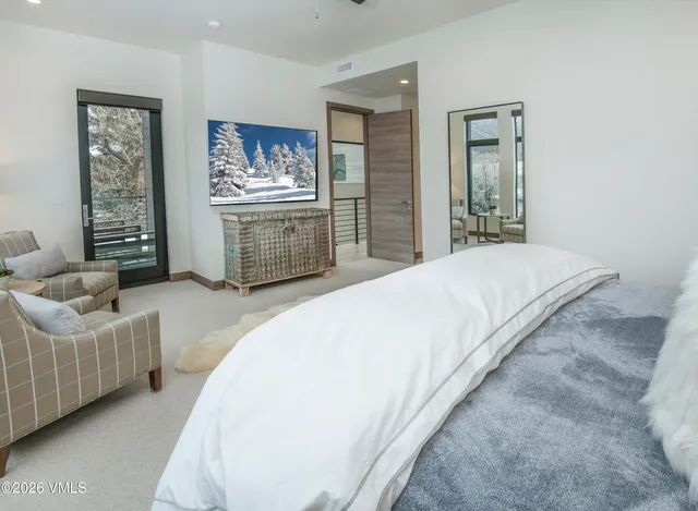 a bedroom with a large bed and a large window