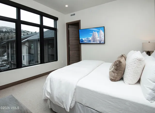 a bathroom with a double vanity sink toilet and a mirror