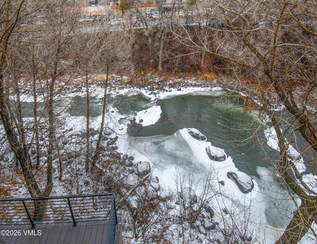 a view of a roof deck with couches and wooden floor