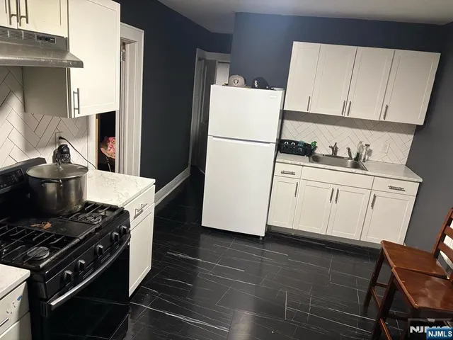 a bathroom with a sink a mirror and bathtub