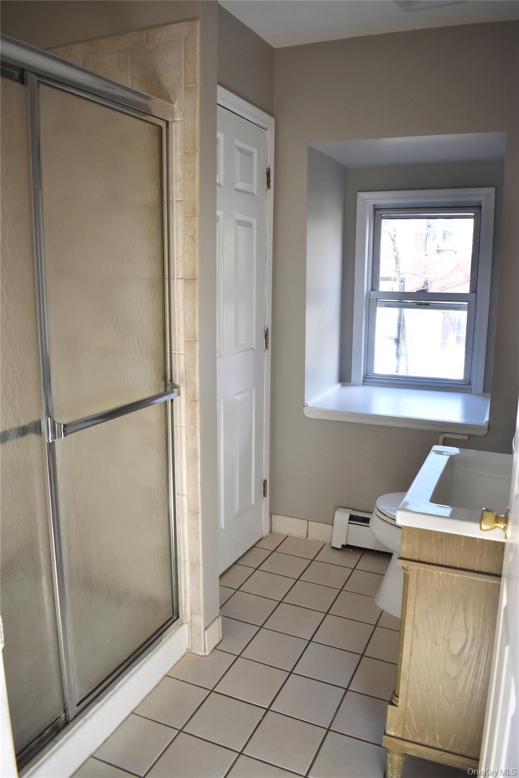 46 Prospect Street, Unit 3 Nyack, NY 10960 - Photo 10 of 12 a room with a window and a refrigerator