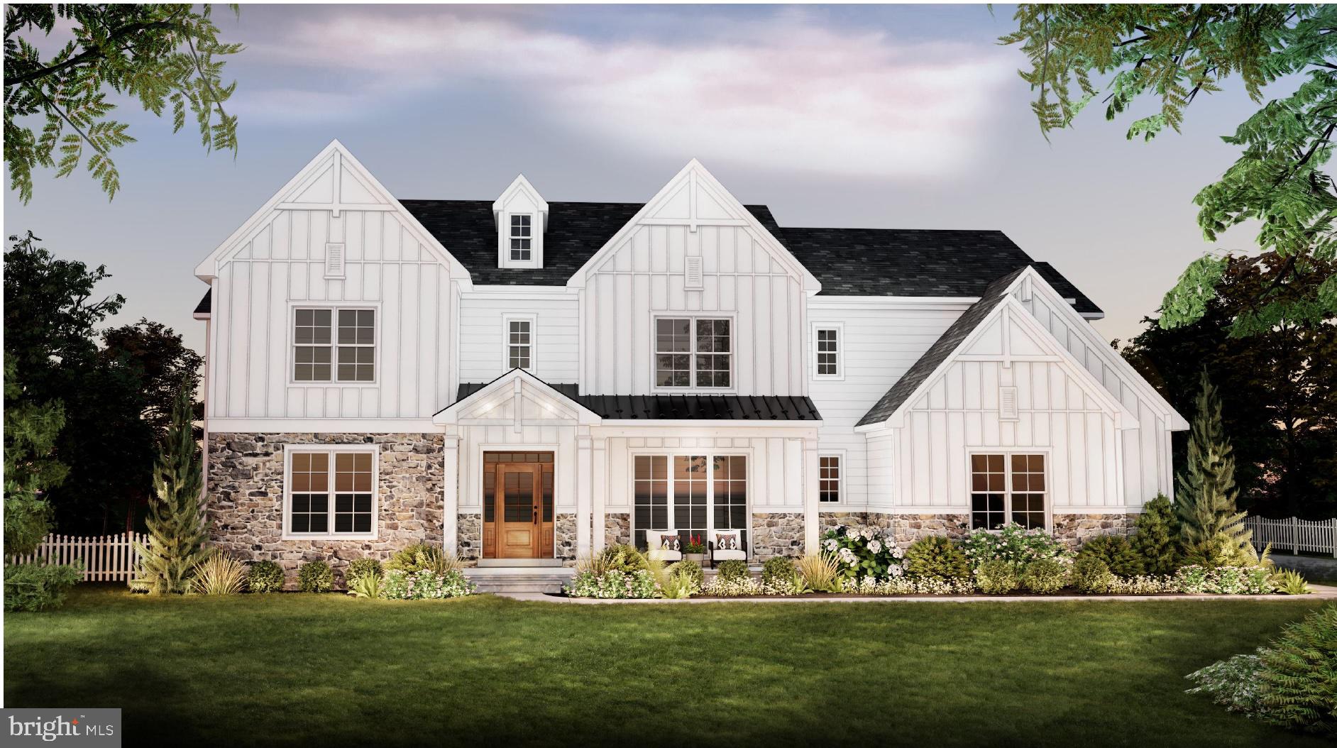 a front view of a house with a garden and trees