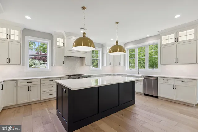 a kitchen with a stove sink and window