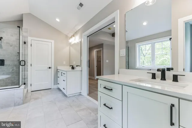 a bathroom with a granite countertop sink mirror and double