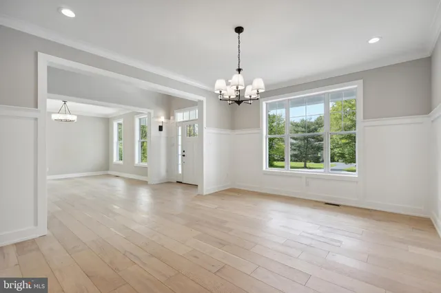 a view of livingroom with chandelier and hardwood floor
