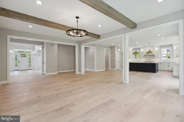 a view of an empty room and kitchen view