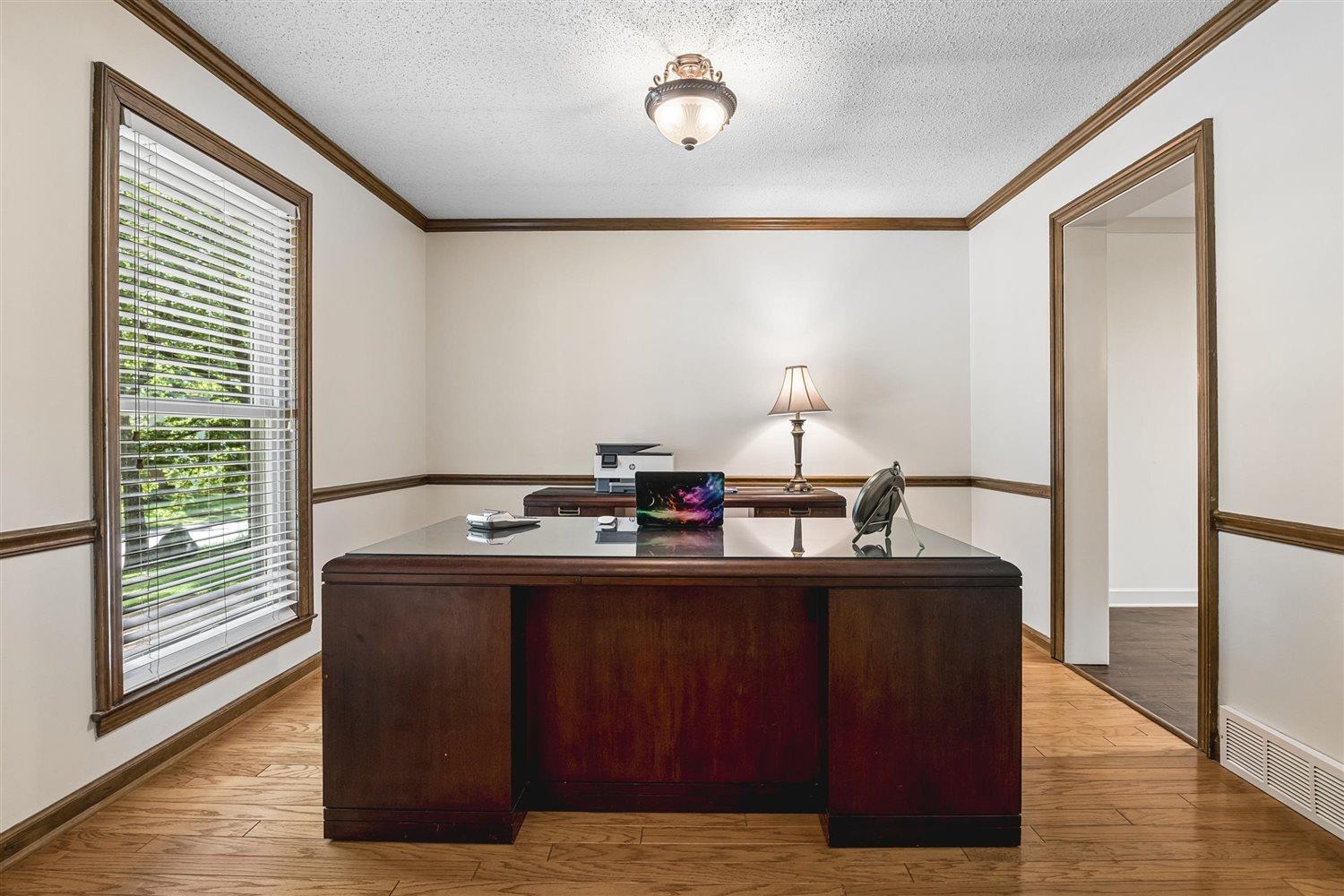 8970 Farmoor Road Germantown, TN 38139 - Photo 5 of 35 Interior room featuring wood-finish flooring, white walls with wood trim and chair rail molding, and a visible window with blinds