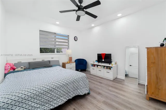 a bedroom with a bed furniture and a flat screen tv