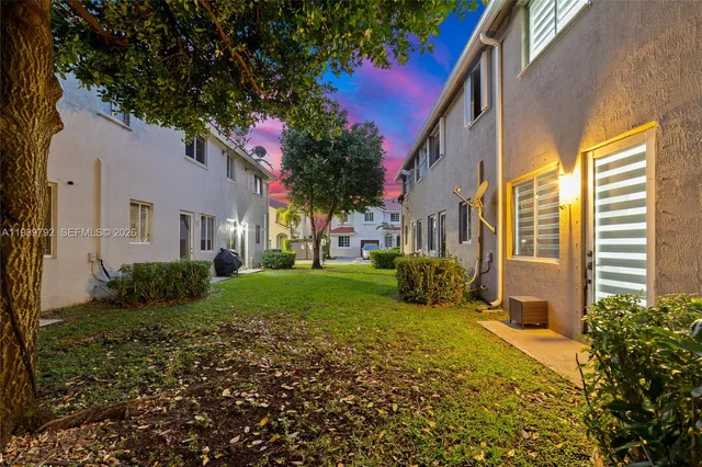 a view of a house with a small yard and plants