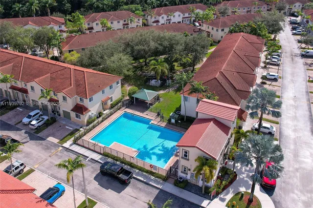 an aerial view of a house with garden space and street view