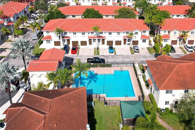 an aerial view of multiple houses with yard