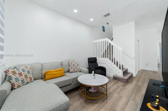 a living room with furniture and a chair
