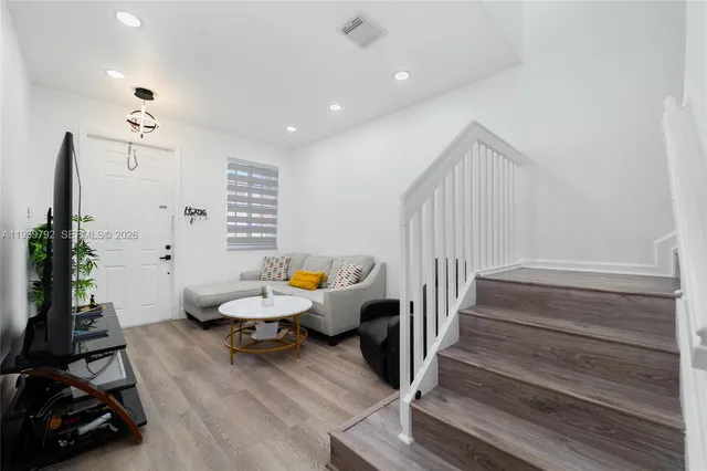 a room with wooden floor and furniture