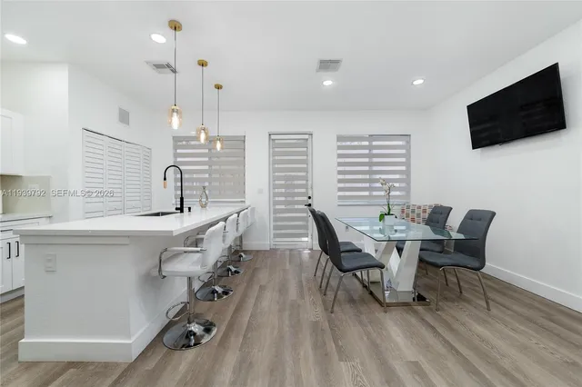 a dining room with furniture and wooden floor