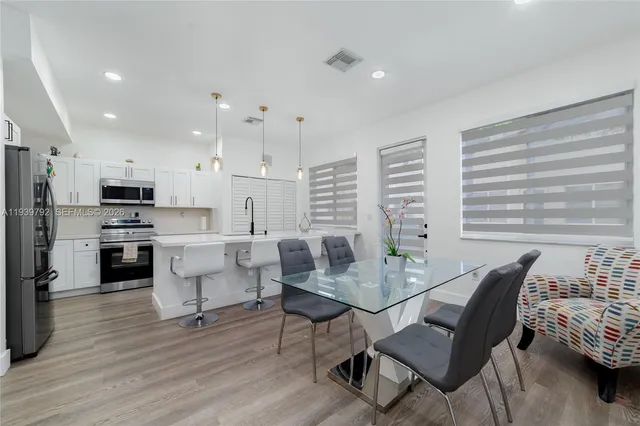 a view of a dining room with furniture and wooden floor