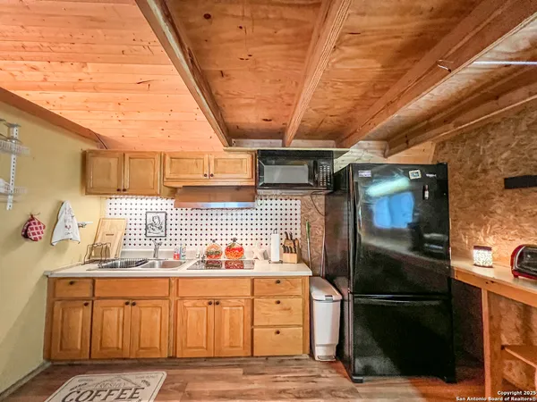 a kitchen with stainless steel appliances granite countertop a refrigerator and a stove