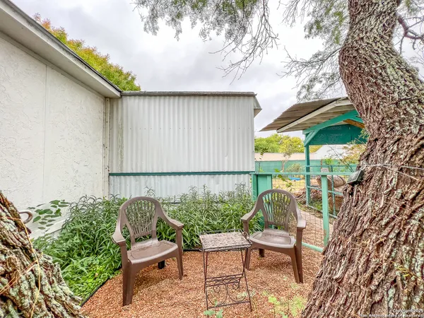 a view of a chair and tables in the patio