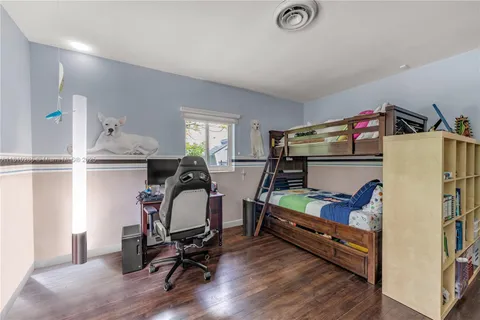 a bedroom with furniture and a wooden floor