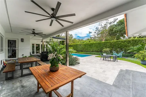 a view of a patio with a dining table and chairs