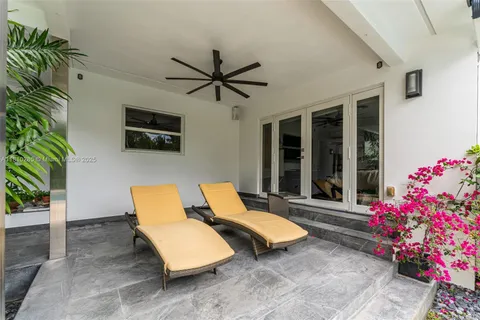 a outdoor space with patio couch and a potted plant