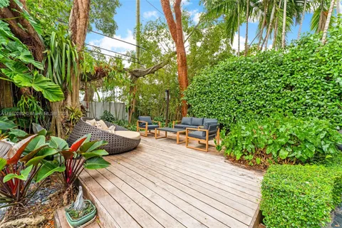 a view of a patio with couches table and chairs and potted plants