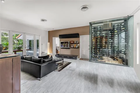 a living room with furniture a large window and flat screen tv