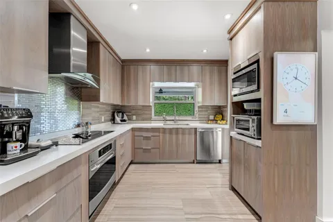 a kitchen with stainless steel appliances granite countertop a stove and a refrigerator