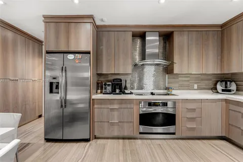 a kitchen with a stove sink and refrigerator