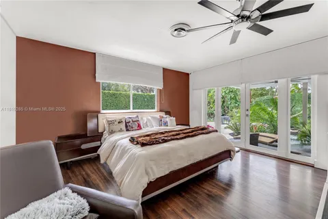 a bedroom with a large bed and a large window