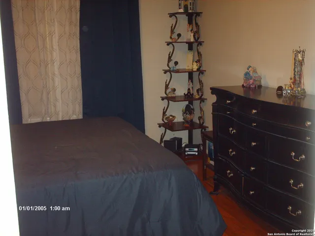 a bed sitting in a bedroom next to a window